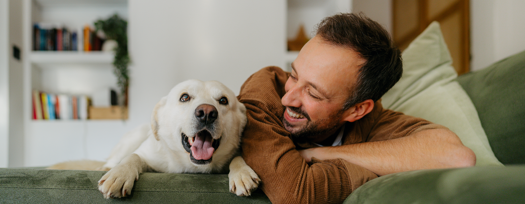 Man next to dog on couch