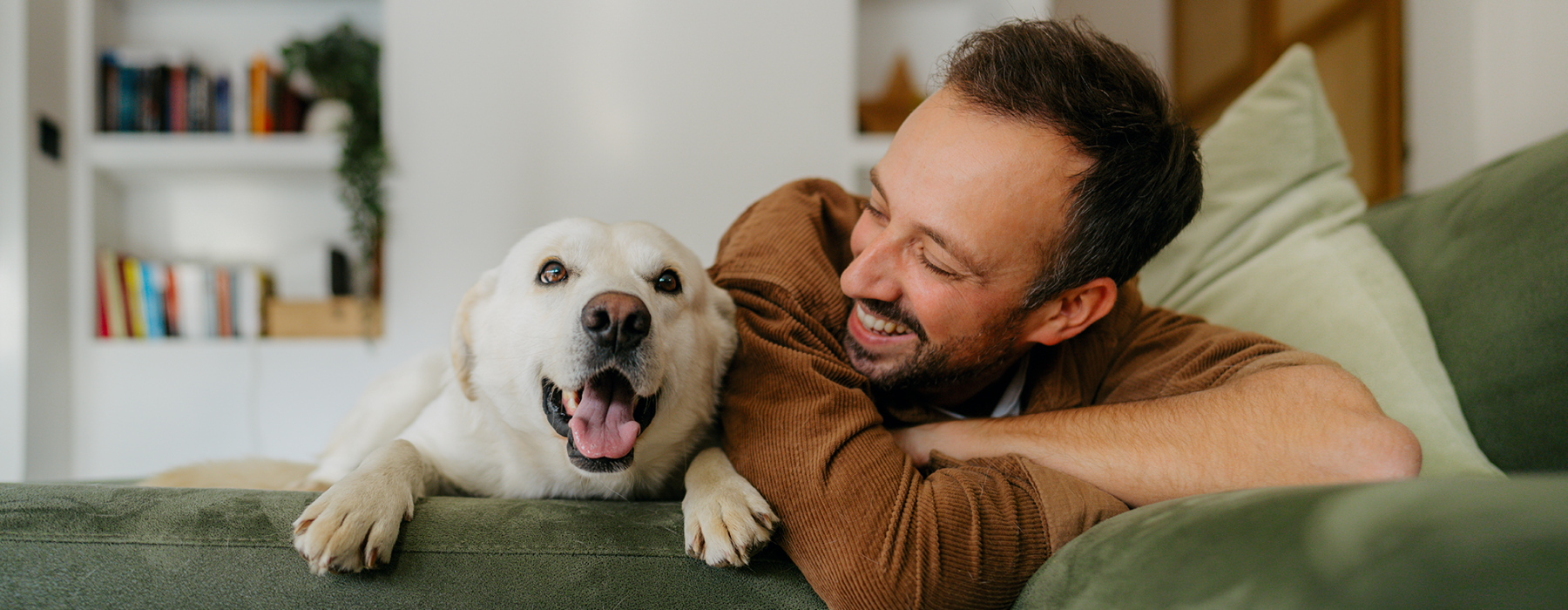 Man next to dog on couch